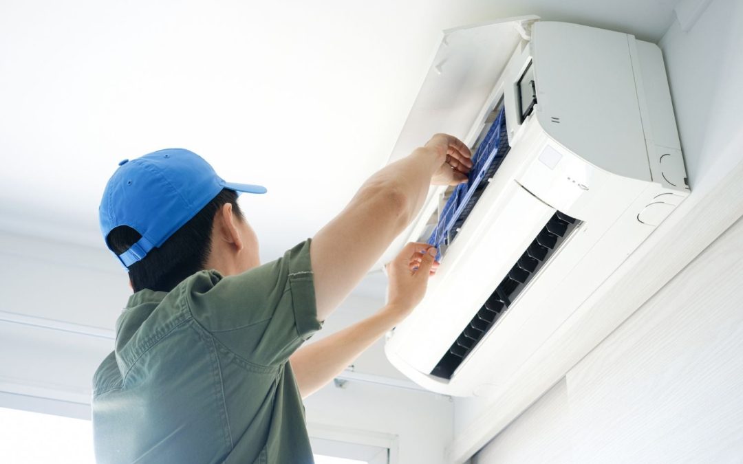 Air conditioning technician maintaining an indoor mini split system in Springville, UT