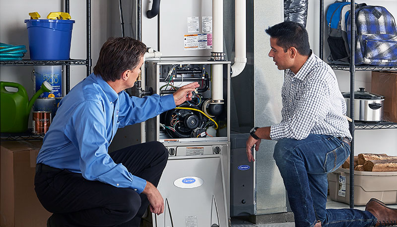 HVAC technician evaluating a furnace for repair or replacement in Springville
