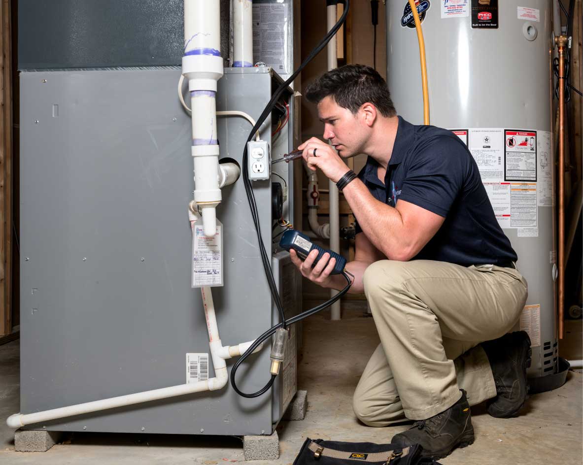 HVAC technician performing a furnace tune-up in Springville