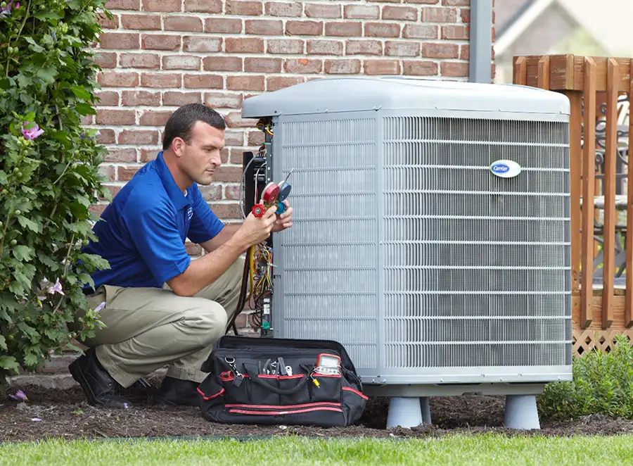 HVAC technician inspecting an outdoor air conditioning unit in Springville