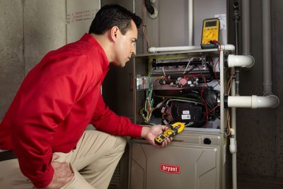 furnace repair Heating and air conditioning technician servicing an indoor furnace in Springville, UT